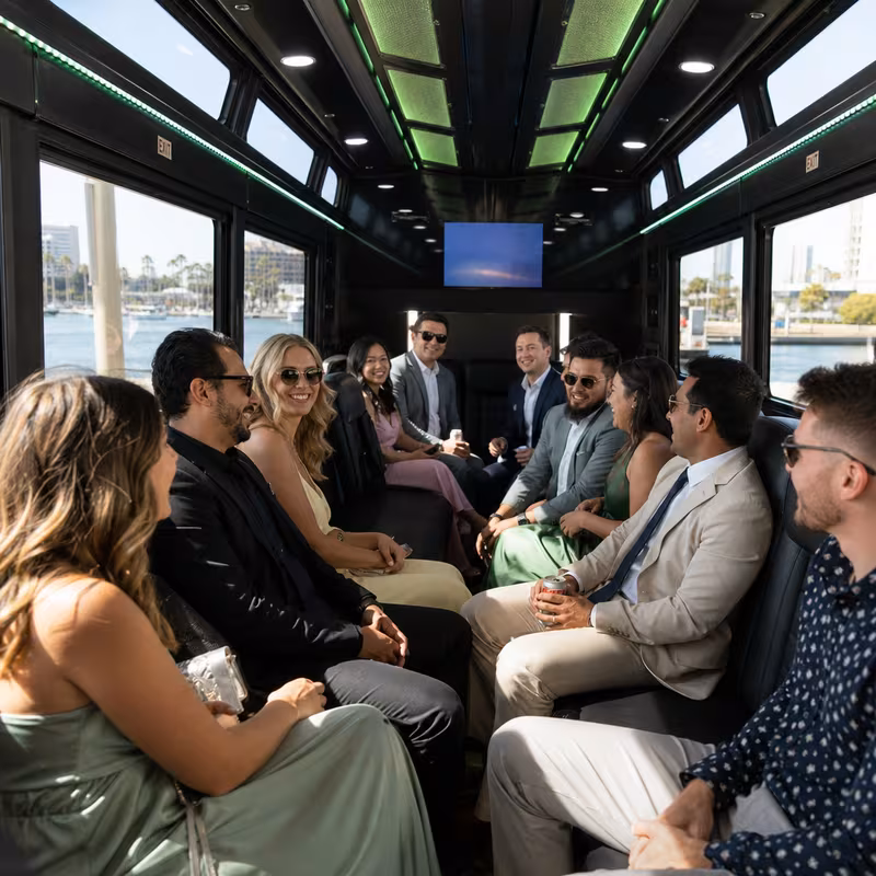Wedding guests seated inside a Long Beach party bus