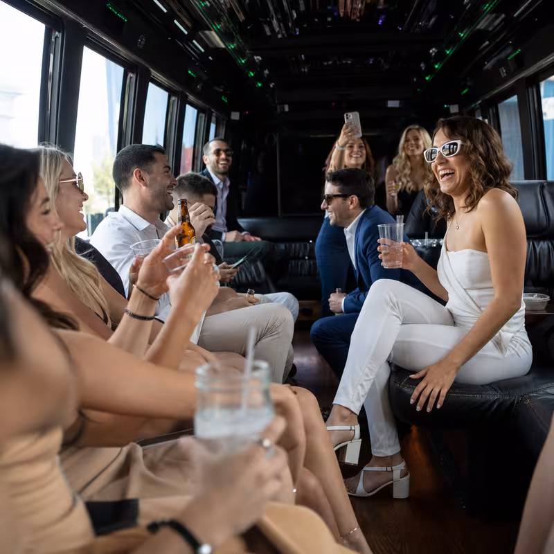 Party bus interior with wraparound leather seating and LED lighting in Long Beach