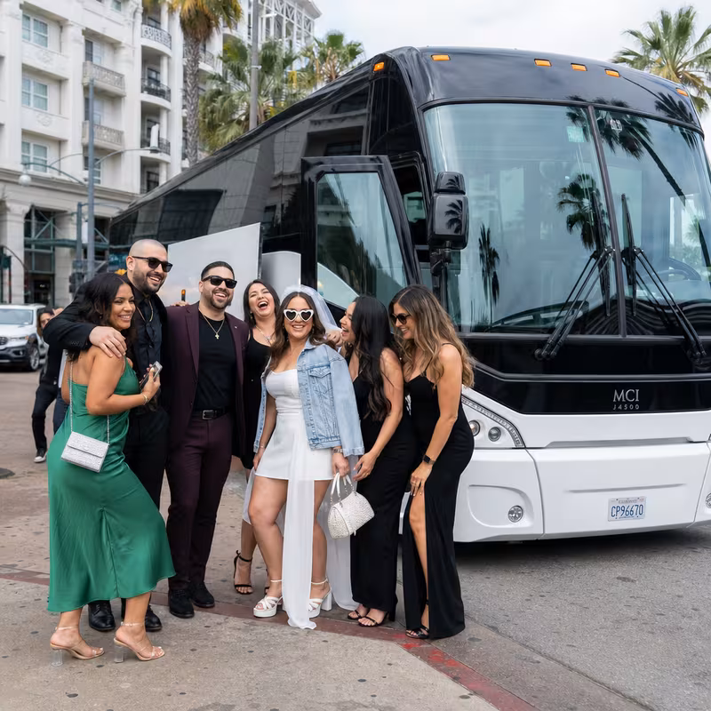 Passengers loading luggage while boarding a Long Beach group shuttle