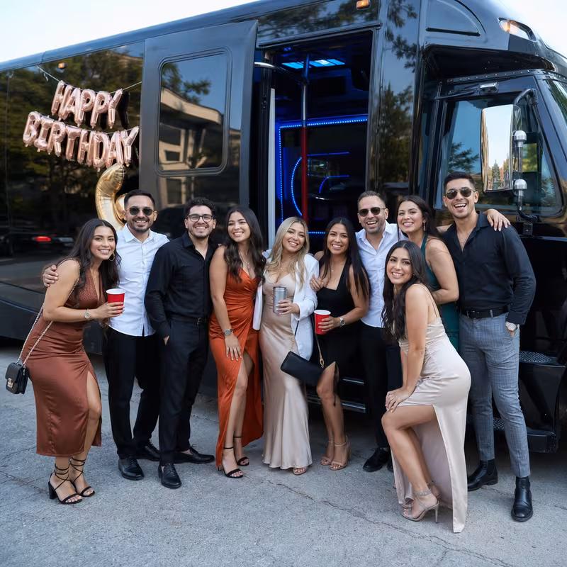 Group boarding a white charter bus for Birthday Transportation transportation in Long Beach
