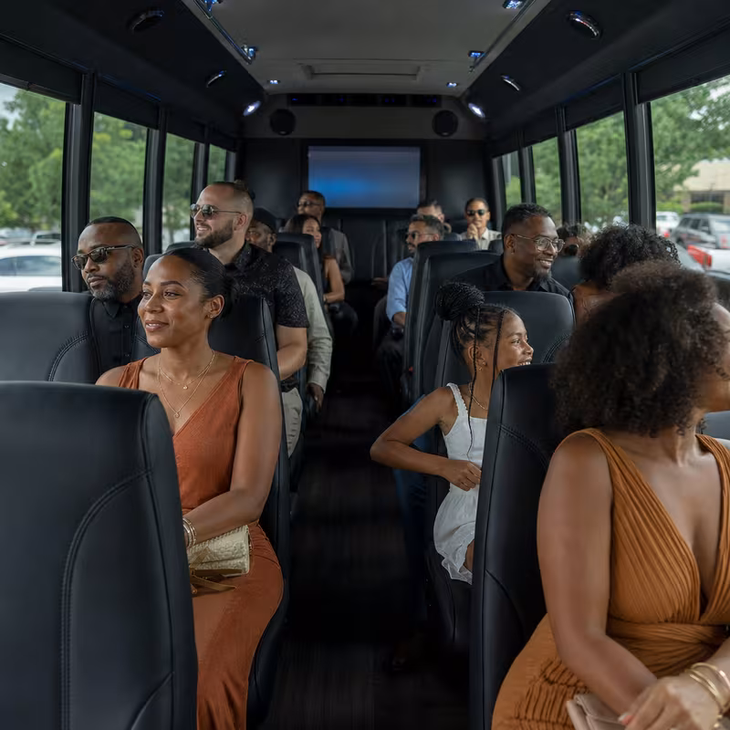 Group boarding a white charter bus for Private Event Transportation transportation in Long Beach