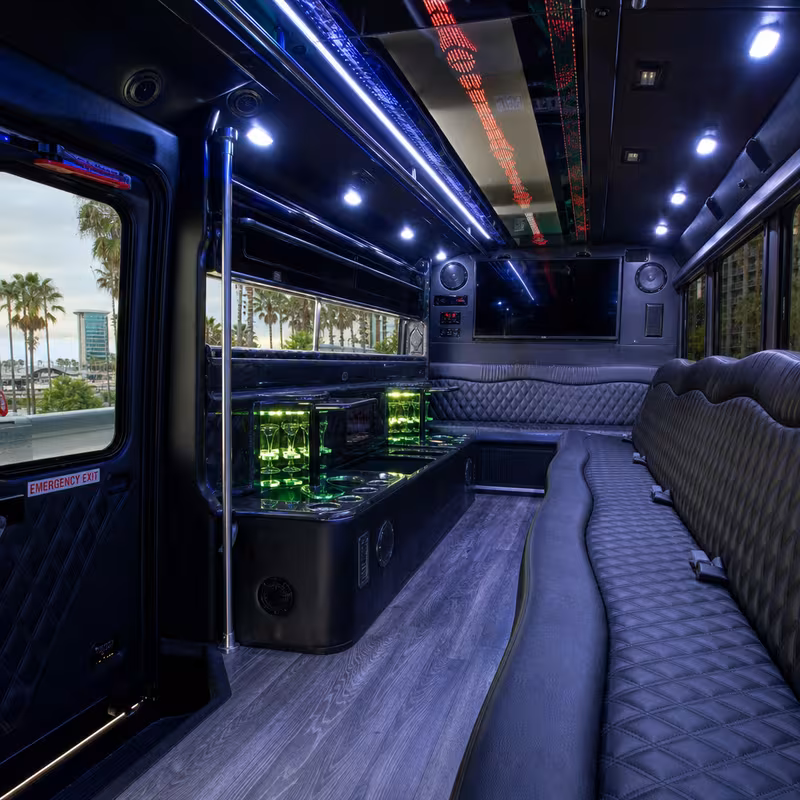 Party bus interior with wraparound leather seating and LED lighting in Long Beach