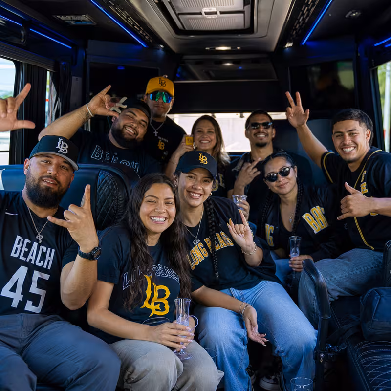 Group boarding a white charter bus for Sporting Event Transportation transportation in Long Beach