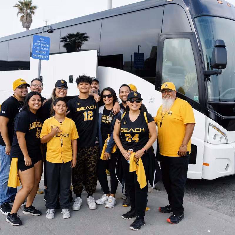 Passengers loading luggage while boarding a Long Beach group shuttle