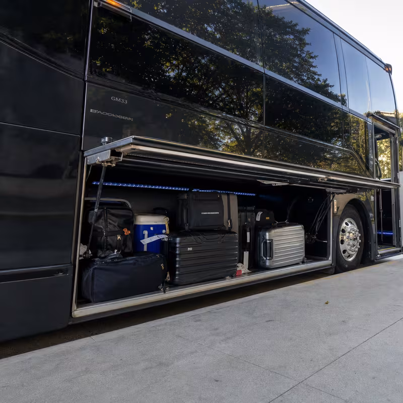 Party bus interior with wraparound leather seating and LED lighting in Long Beach