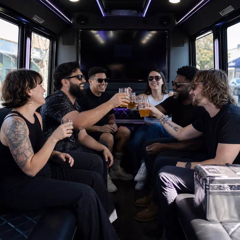 Group boarding a white charter bus for Winery & Brewery Tour Transportation transportation in Long Beach