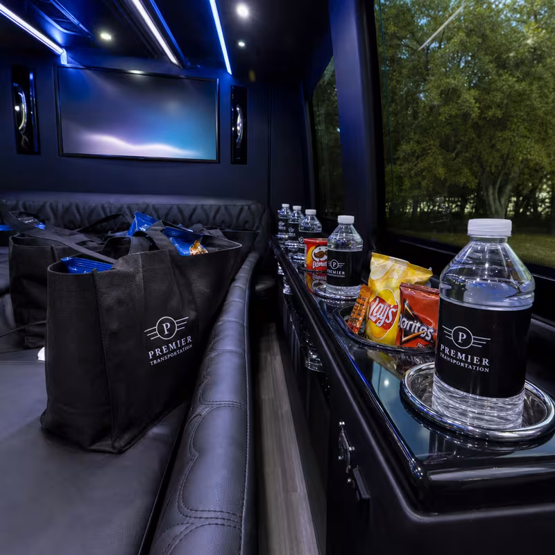 Party bus interior with wraparound leather seating and LED lighting in Long Beach